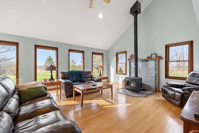1808 County Road 18th Rd, Waterloo, IN 46793 - living area with a ceiling fan, high vaulted ceiling, light wood-style flooring, and a wood stove