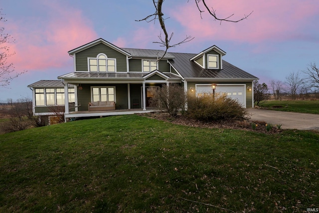 1808 County Road 18th Rd, Waterloo, IN 46793 - view of front facade featuring a porch, metal roof, a garage, a front lawn, and concrete driveway