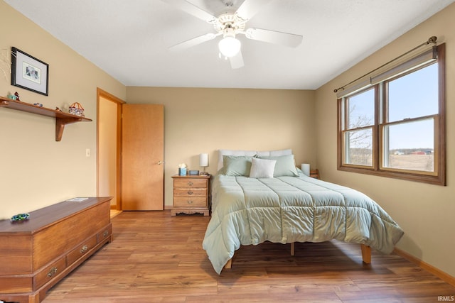 1808 County Road 18th Rd, Waterloo, IN 46793 - bedroom featuring a ceiling fan, baseboards, and light wood-style flooring