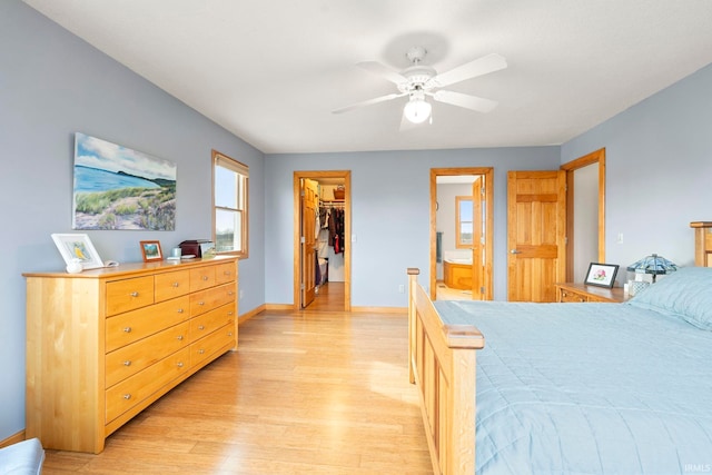 1808 County Road 18th Rd, Waterloo, IN 46793 - bedroom featuring a closet, baseboards, connected bathroom, a spacious closet, and light wood finished floors