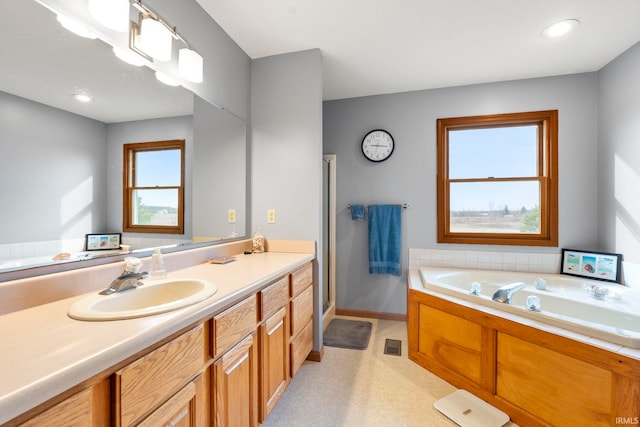 1808 County Road 18th Rd, Waterloo, IN 46793 - full bathroom with vanity, baseboards, a garden tub, and a stall shower