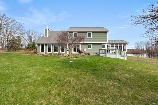 1808 County Road 18th Rd, Waterloo, IN 46793 - rear view of property featuring metal roof, a sunroom, a yard, and a chimney