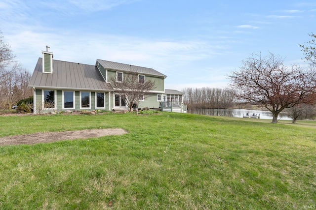 1808 County Road 18th Rd, Waterloo, IN 46793 - back of property featuring a chimney, a yard, a standing seam roof, metal roof, and a water view