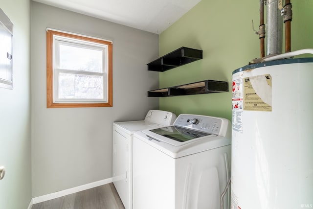 laundry room with gas water heater, washer and clothes dryer, laundry area, baseboards, and wood finished floors