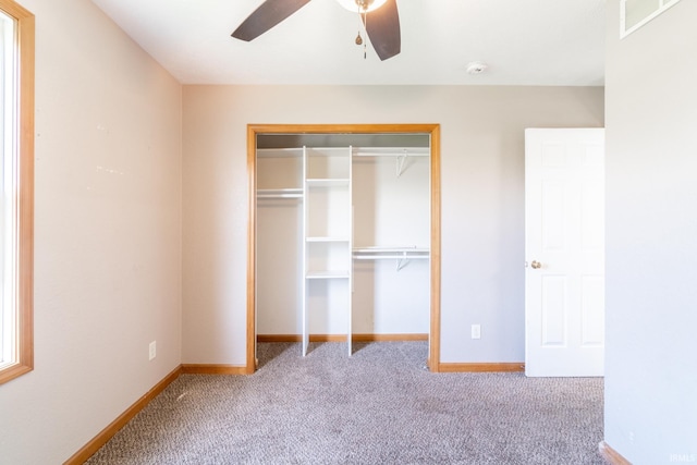 unfurnished bedroom with carpet, visible vents, a closet, and baseboards