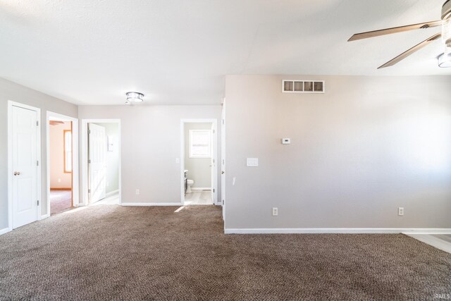 unfurnished room featuring visible vents, ceiling fan, carpet flooring, and baseboards