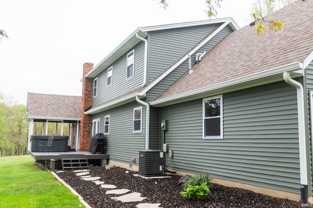 6021 N Timberline Dr, Bloomington, IN 47404 - rear view of property with a wooden deck, a chimney, a shingled roof, central air condition unit, and a yard