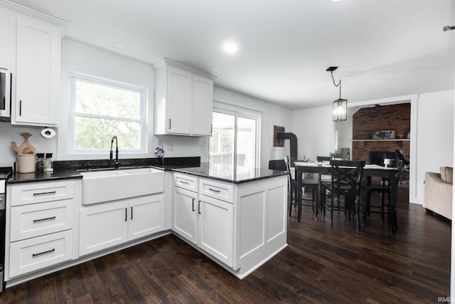 6021 N Timberline Dr, Bloomington, IN 47404 - kitchen featuring a peninsula, plenty of natural light, white cabinets, and a sink