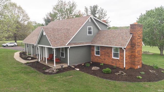 6021 N Timberline Dr, Bloomington, IN 47404 - back of property featuring a chimney, a shingled roof, a lawn, a porch, and brick siding