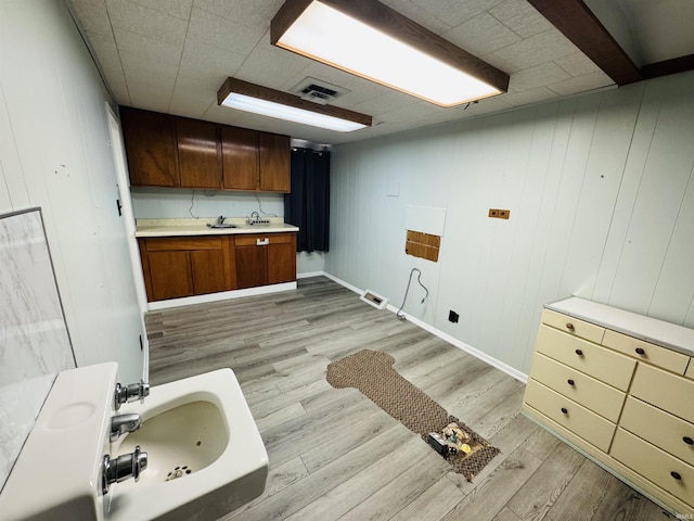 bathroom featuring a sink, visible vents, and wood finished floors