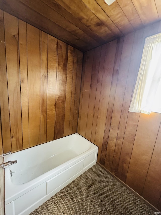 full bathroom featuring wood walls, a tub, and wood ceiling