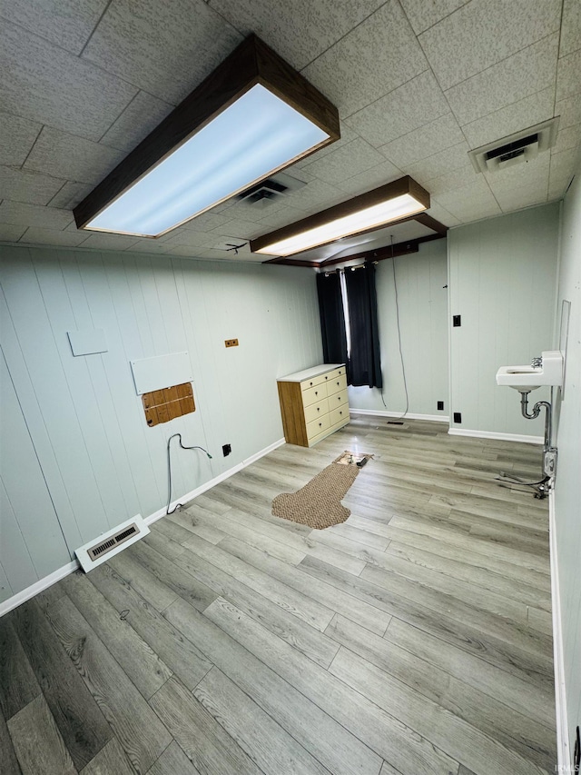 laundry room featuring wood finished floors, visible vents, and baseboards