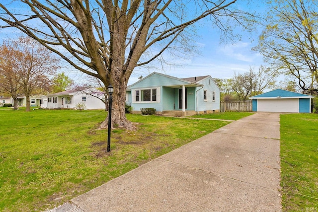 bungalow-style home with a garage, an outdoor structure, and a front yard