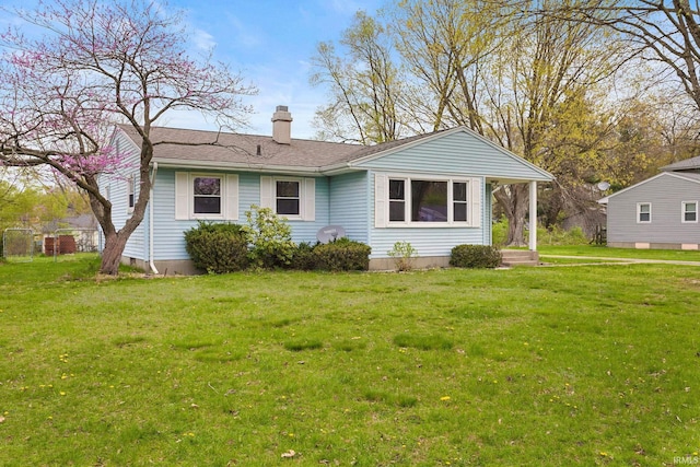 view of front of home with a chimney and a front yard