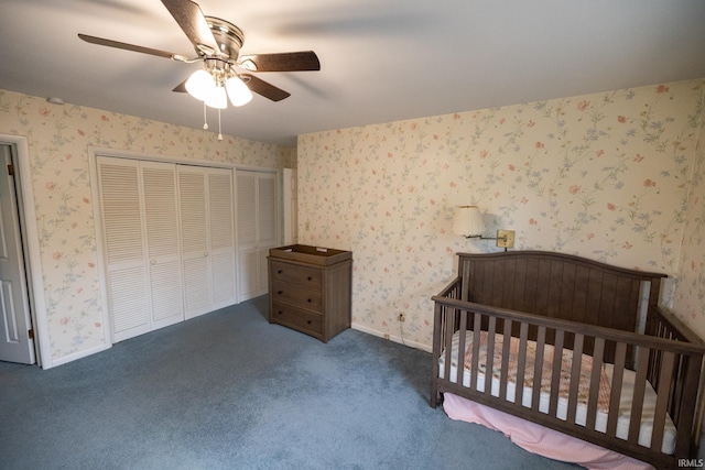 bedroom with wallpapered walls, a closet, ceiling fan, carpet flooring, and baseboards