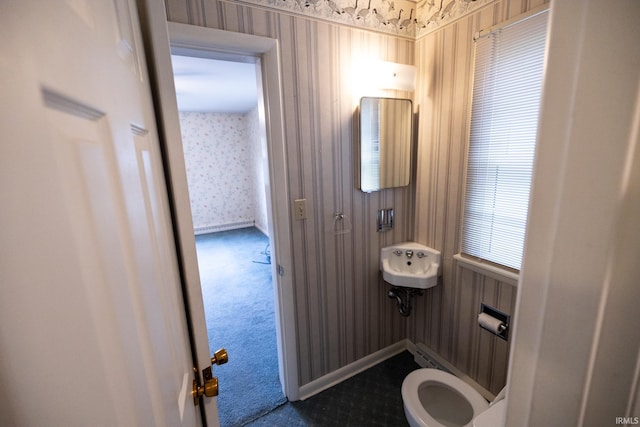 bathroom featuring toilet and wallpapered walls