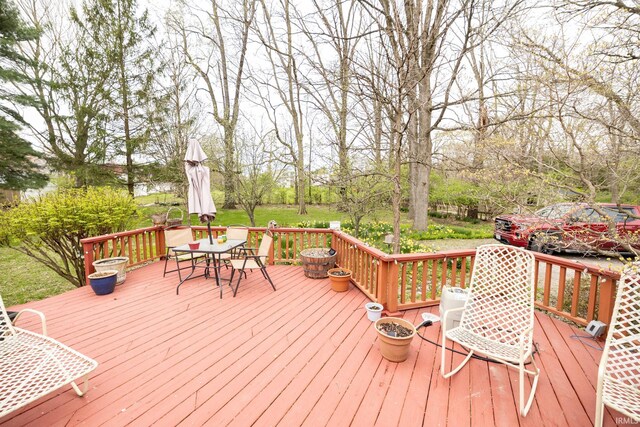 wooden terrace featuring outdoor dining space