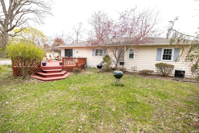 rear view of house with a deck, central AC, and a lawn