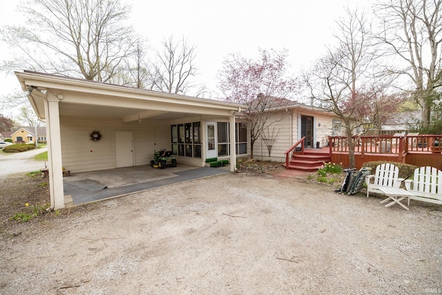exterior space with a deck and a sunroom