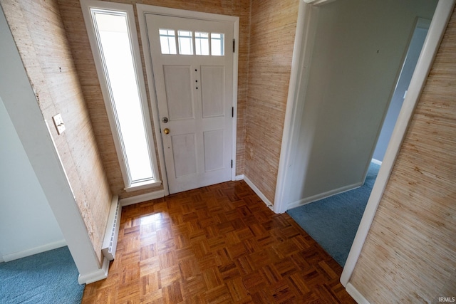 foyer featuring baseboard heating and baseboards