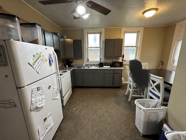 kitchen with dark colored carpet, light countertops, white appliances, a ceiling fan, and gray cabinets