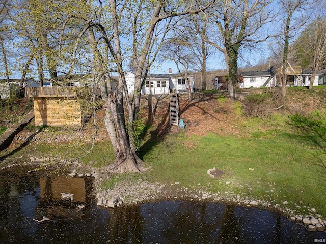 view of yard featuring stairs and a water view