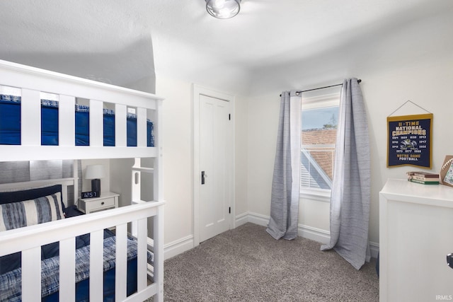 unfurnished bedroom featuring carpet and baseboards