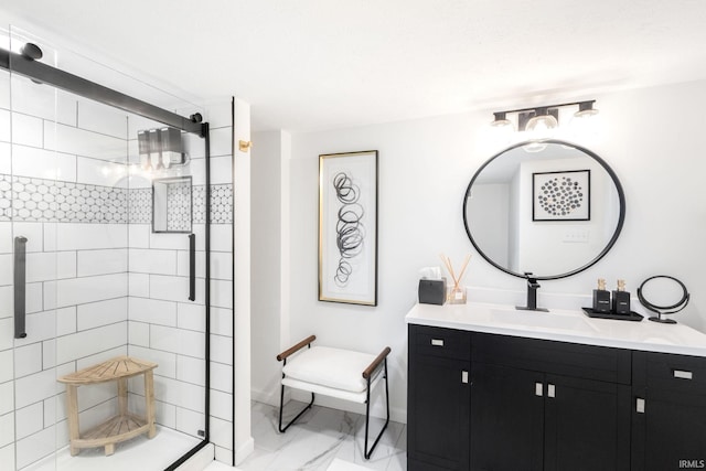 bathroom featuring baseboards, a shower stall, vanity, and marble finish floor