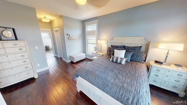 bedroom featuring baseboards, ceiling fan, and wood-type flooring