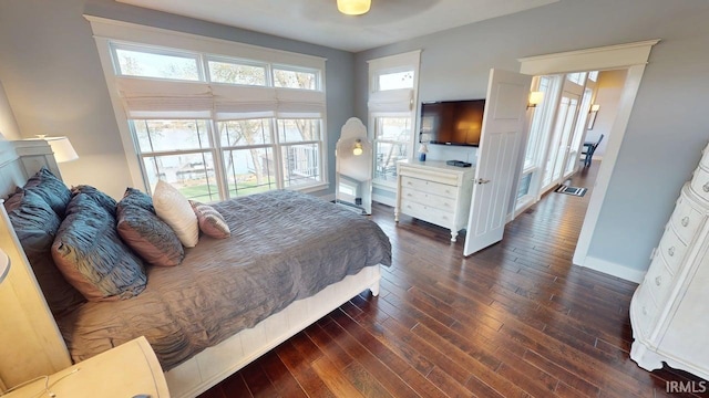 bedroom featuring dark wood-style floors and baseboards