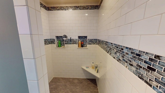 bathroom with tiled shower