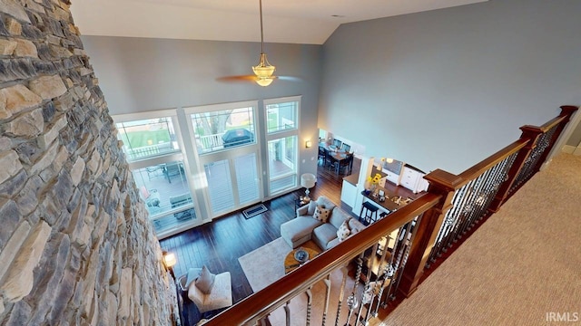 interior space with lofted ceiling, ceiling fan, and wood finished floors