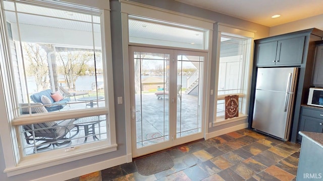 entryway with stone finish flooring, a healthy amount of sunlight, and recessed lighting