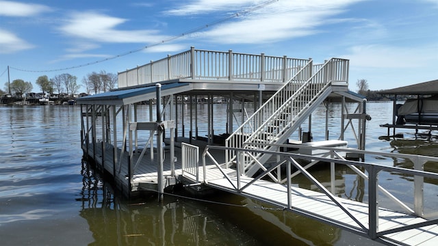 view of dock featuring stairway, a water view, and boat lift