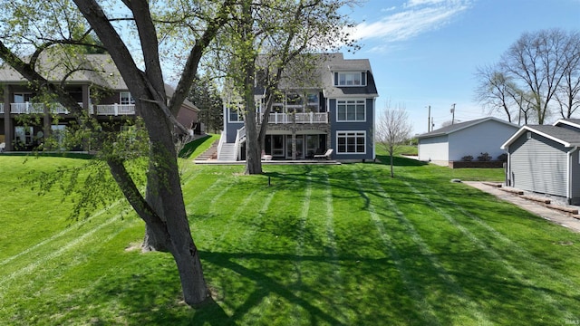back of property with a lawn, stairway, and a deck