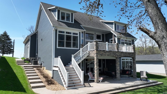 back of house featuring an outdoor hangout area, a deck, a patio area, a shingled roof, and stairway