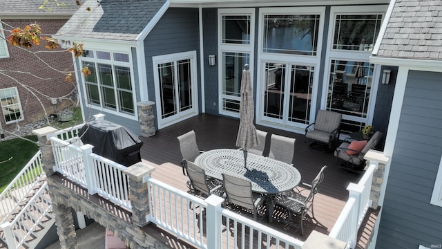 wooden deck featuring outdoor dining area