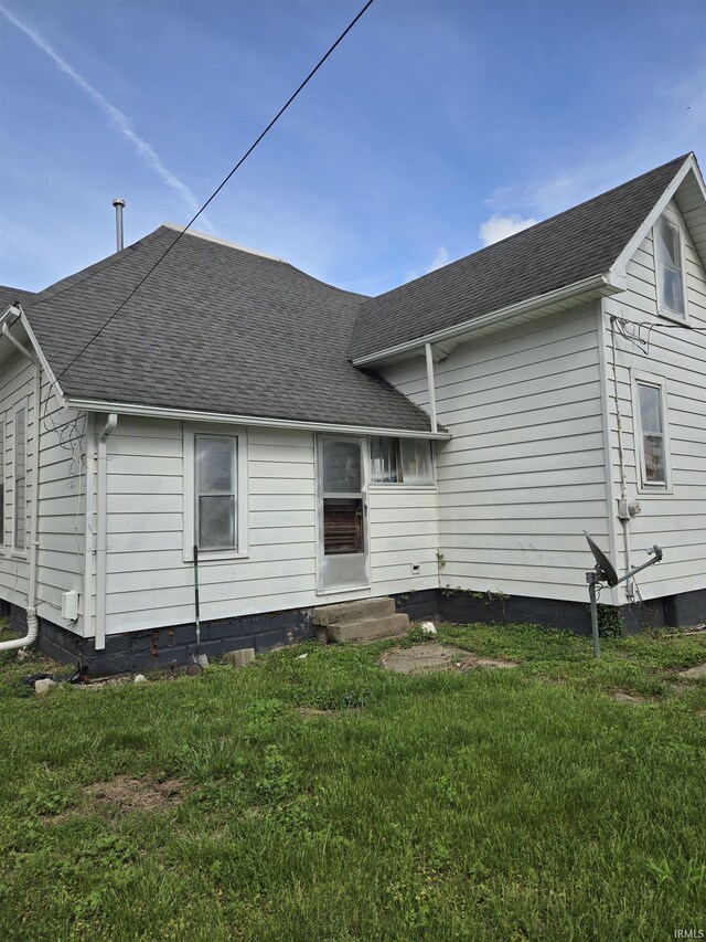1225 Main St, Vincennes, IN 47591 - rear view of property featuring a yard, entry steps, and roof with shingles