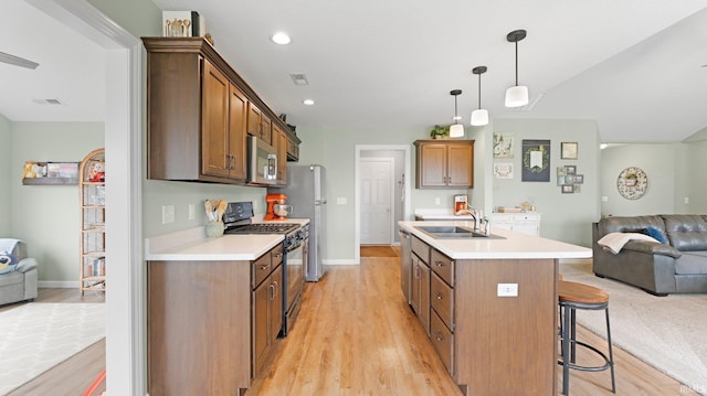 1905 Waynedale Dr, Garrett, IN 46738 - kitchen featuring stainless steel appliances, a sink, light wood-style flooring, and open floor plan