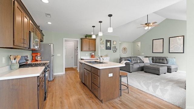 1905 Waynedale Dr, Garrett, IN 46738 - kitchen with stainless steel appliances, a sink, visible vents, open floor plan, and a kitchen breakfast bar