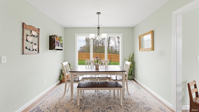 1905 Waynedale Dr, Garrett, IN 46738 - dining room with an inviting chandelier, wood finished floors, and baseboards