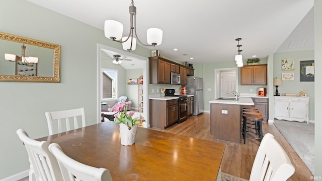 1905 Waynedale Dr, Garrett, IN 46738 - dining space featuring light wood-type flooring, baseboards, recessed lighting, and ceiling fan with notable chandelier