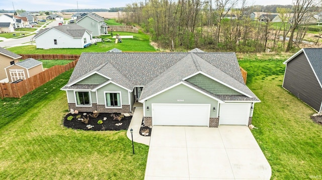 1905 Waynedale Dr, Garrett, IN 46738 - view of front facade with brick siding, fence, a residential view, roof with shingles, and an attached garage