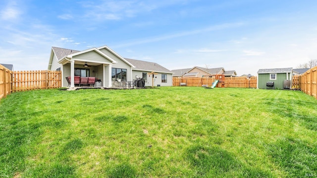 1905 Waynedale Dr, Garrett, IN 46738 - rear view of house with a fenced backyard, a yard, ceiling fan, a shed, and a playground