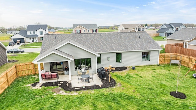 1905 Waynedale Dr, Garrett, IN 46738 - rear view of house featuring a lawn, a patio area, and a residential view