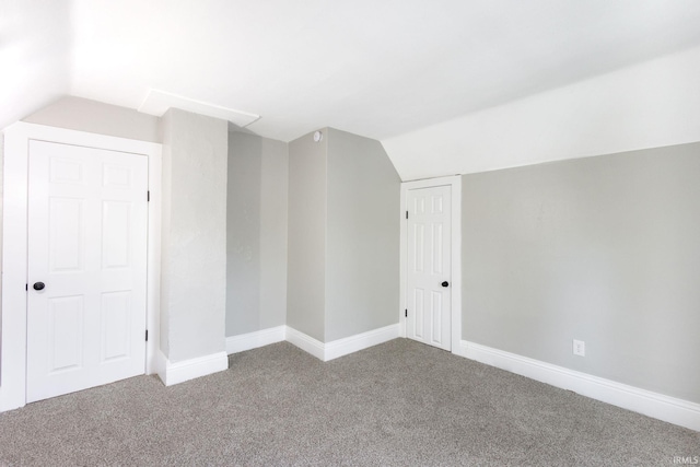 additional living space featuring carpet flooring, vaulted ceiling, and baseboards