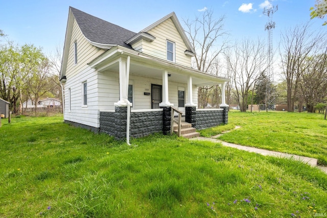 bungalow-style home featuring a porch, a front yard, and roof with shingles