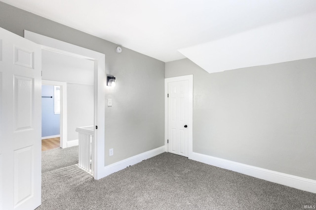 empty room featuring baseboards and carpet floors