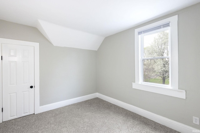 bonus room with vaulted ceiling, carpet floors, and baseboards