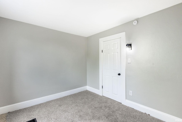 spare room with carpet and baseboards